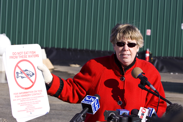 Judith Enck, EPA Region II REgional Administrator shows fish consumption advosry warning of PCB toxic contamination of fish in Bound Brook. 