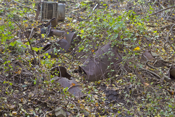 chemical drums, tires, bubble to surface of landfill