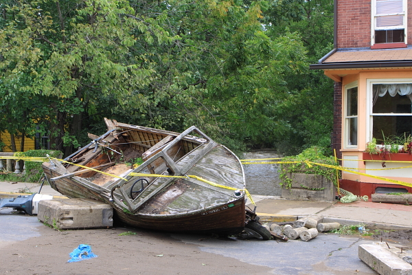 Lambertville - (South Union Street). Boat washed up in road, over bridge across Swan Creek, in background