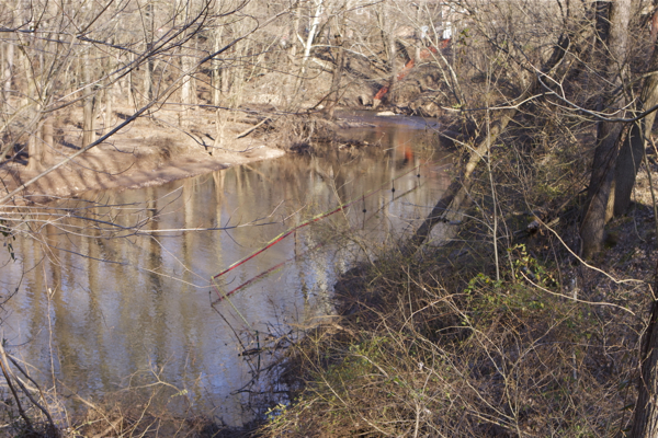 notice the police tape restricting access to the stream bank, which is washing out and collapsing into the stream!